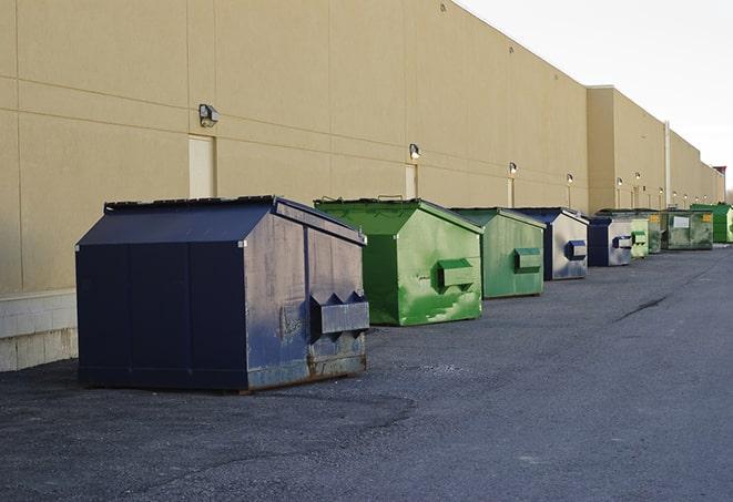 construction workers throw waste into a dumpster behind a building in Highland Park NJ